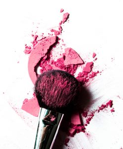 Crushed pink eyeshadow and make-up brush